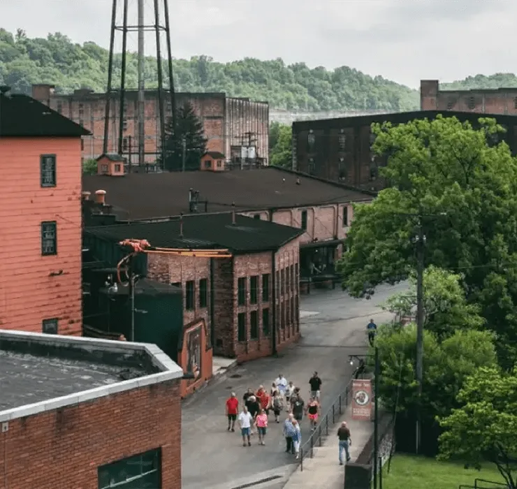 is Buffalo Trace Distillery worth visiting: tour group among aging warehouses in Frankfort Kentucky